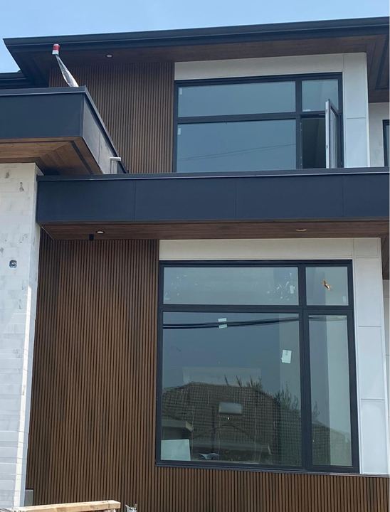 Fluted panelling and stone cladding on a completed Lower Mainland home